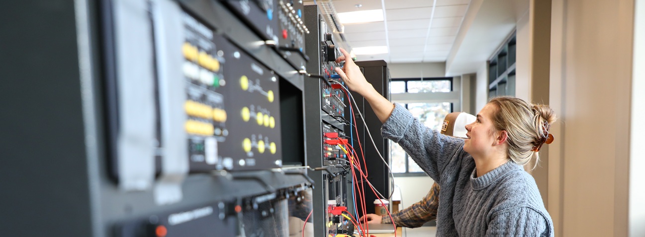 Electrical engineering student using lab equipment