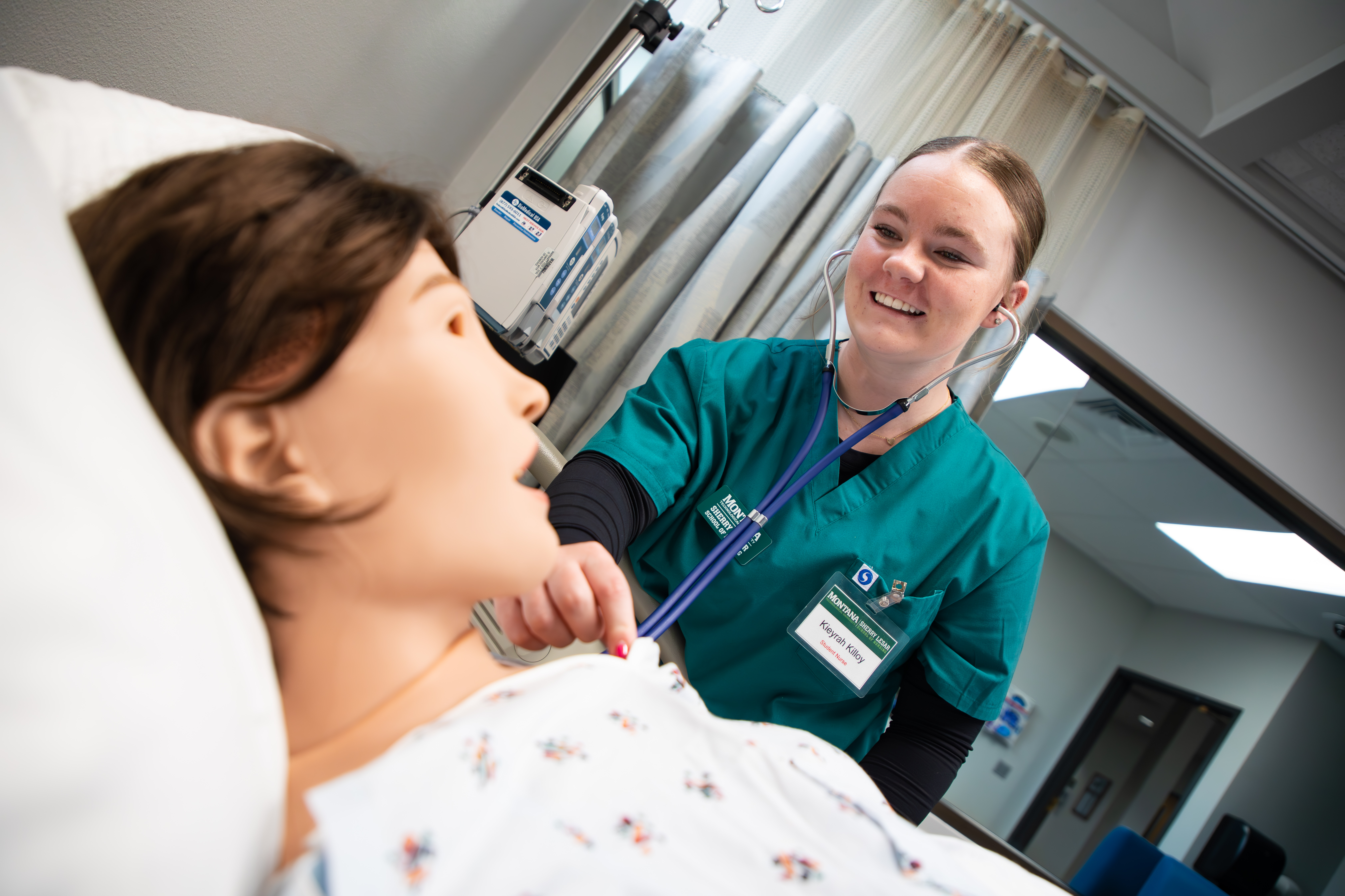 Nursing students performing CPR on a mannequin