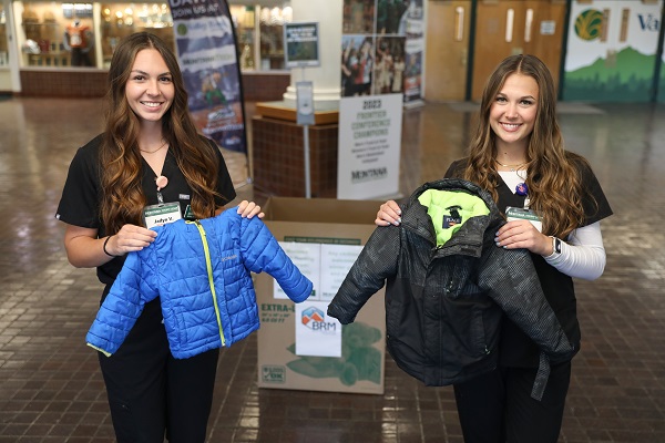 !Students pose with small coats