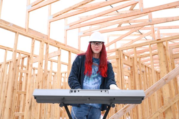 !Denali in a hardhat playing a keyboard