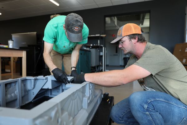 Photo: Dr. Nathan Huft and Daniel Topp assemble the replica of Death of Cleopatra by Edmonia Lewis.