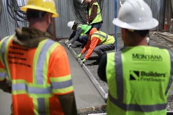 !Students work with poured concrete