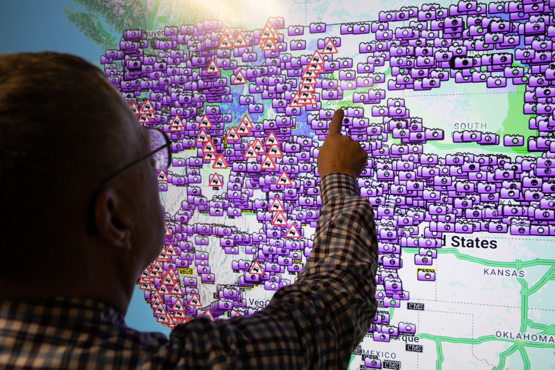 Doug Galarus in front of smartboard with OSS website behind him